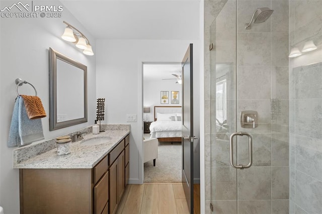 3565 Rosette Grv, Colorado Springs, CO 80910 - ensuite bathroom featuring wood finished floors, a shower stall, ceiling fan, and vanity