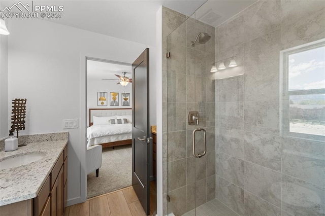 3565 Rosette Grv, Colorado Springs, CO 80910 - full bath featuring wood finished floors, ensuite bathroom, a shower stall, vanity, and a ceiling fan
