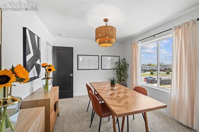 3565 Rosette Grv, Colorado Springs, CO 80910 - dining room with carpet floors, baseboards, and a chandelier