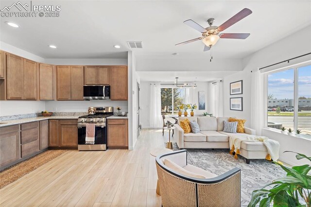 3565 Rosette Grv, Colorado Springs, CO 80910 - kitchen featuring stainless steel appliances, light wood-style flooring, healthy amount of natural light, recessed lighting, and open floor plan