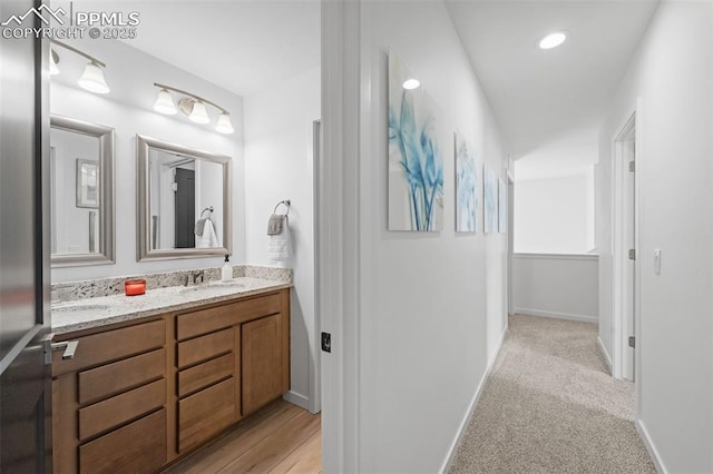 3565 Rosette Grv, Colorado Springs, CO 80910 - bathroom with double vanity and baseboards