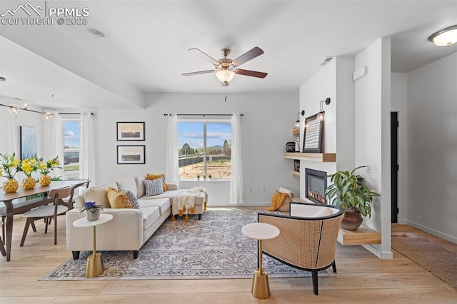 3565 Rosette Grv, Colorado Springs, CO 80910 - living room featuring healthy amount of natural light, ceiling fan, and light wood finished floors