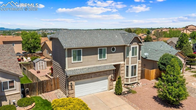 4280 Solarglen Dr, Colorado Springs, CO 80916 - view of front of home with driveway, a garage, fence, a residential view, and brick siding