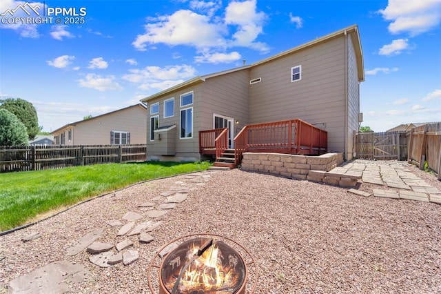 4280 Solarglen Dr, Colorado Springs, CO 80916 - rear view of house with a fire pit, a wooden deck, and a gate