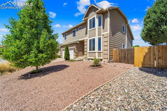 4280 Solarglen Dr, Colorado Springs, CO 80916 - traditional-style house with fence and an attached garage