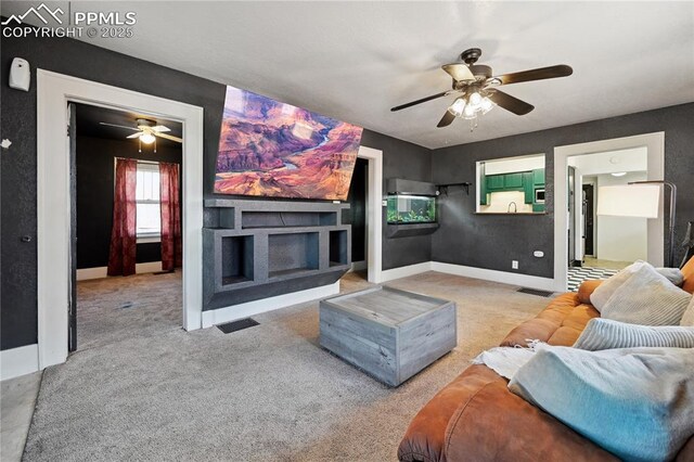510 Brown Ave, Pueblo, CO 81004 - carpeted living room with ceiling fan, a fireplace, and baseboards