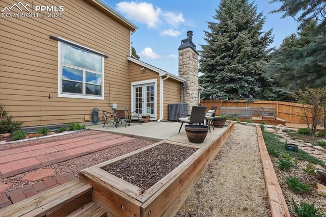 4765 Signal Rock Rd, Colorado Springs, CO 80922 - rear view of property featuring french doors, a patio, fence, central AC unit, and a chimney
