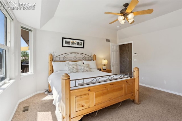 bedroom featuring light colored carpet, baseboards, and a ceiling fan