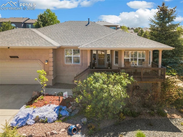 ranch-style house featuring a shingled roof, an attached garage, and concrete driveway