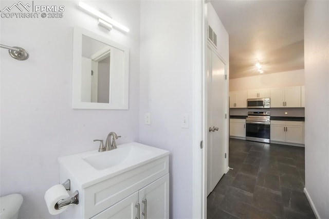 1833 Reilly Grv, Colorado Springs, CO 80951 - bathroom with vanity, toilet, and stone finish flooring