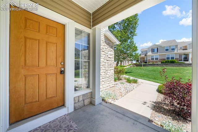 1833 Reilly Grv, Colorado Springs, CO 80951 - doorway to property with stone siding, a lawn, and a residential view