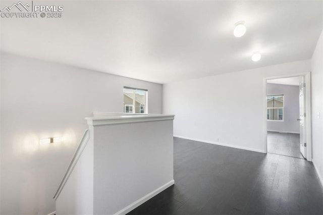 1833 Reilly Grv, Colorado Springs, CO 80951 - spare room featuring baseboards and dark wood-style flooring