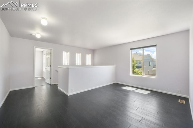 1833 Reilly Grv, Colorado Springs, CO 80951 - spare room featuring plenty of natural light, baseboards, and dark wood-style flooring