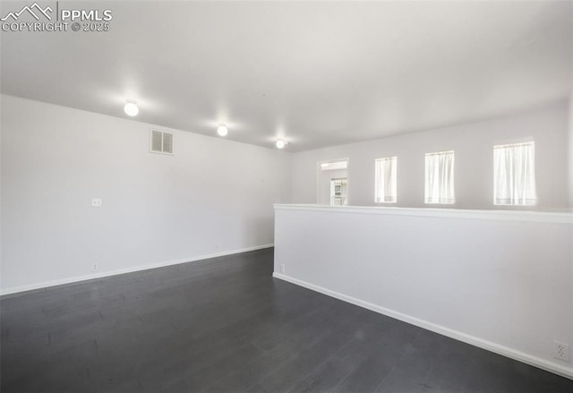 1833 Reilly Grv, Colorado Springs, CO 80951 - spare room featuring baseboards and dark wood finished floors