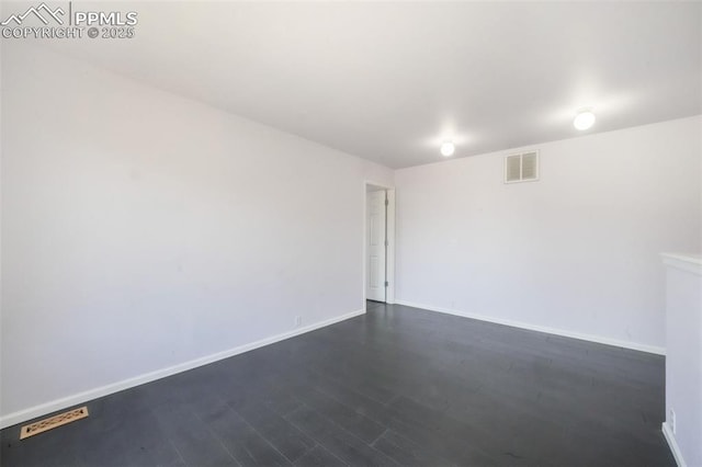 1833 Reilly Grv, Colorado Springs, CO 80951 - spare room with dark wood-style flooring and baseboards