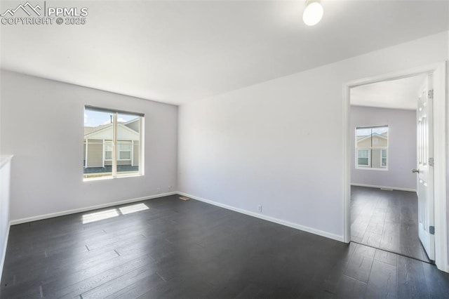1833 Reilly Grv, Colorado Springs, CO 80951 - empty room featuring dark wood-type flooring and baseboards