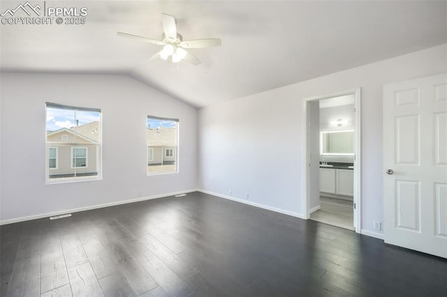 1833 Reilly Grv, Colorado Springs, CO 80951 - unfurnished bedroom featuring dark wood-style floors, lofted ceiling, baseboards, ensuite bath, and ceiling fan