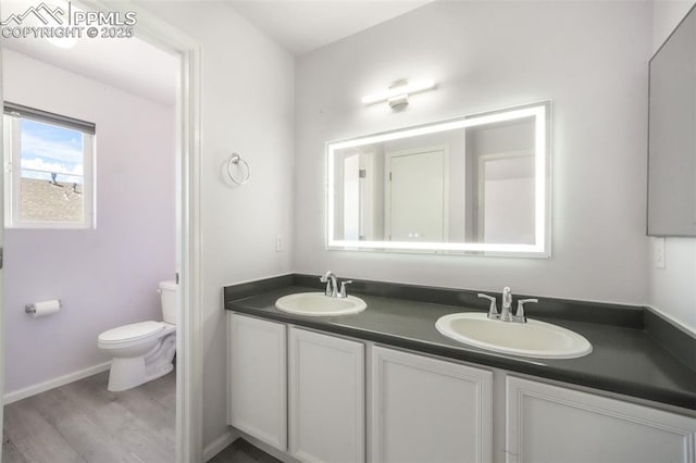 1833 Reilly Grv, Colorado Springs, CO 80951 - full bath with wood finished floors, toilet, and double vanity