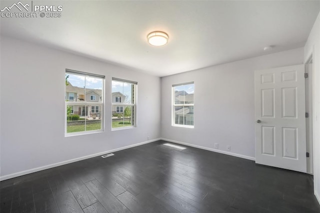 1833 Reilly Grv, Colorado Springs, CO 80951 - spare room featuring baseboards and dark wood-type flooring