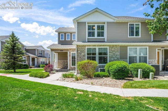 1833 Reilly Grv, Colorado Springs, CO 80951 - view of front of house featuring stone siding, a front yard, a porch, and a shingled roof