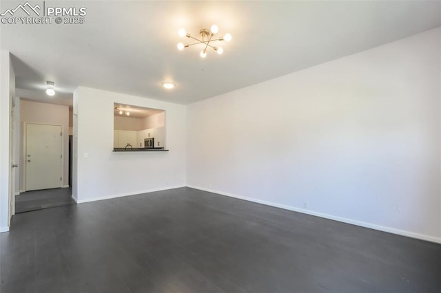 1833 Reilly Grv, Colorado Springs, CO 80951 - unfurnished living room featuring a chandelier, baseboards, and dark wood-style floors