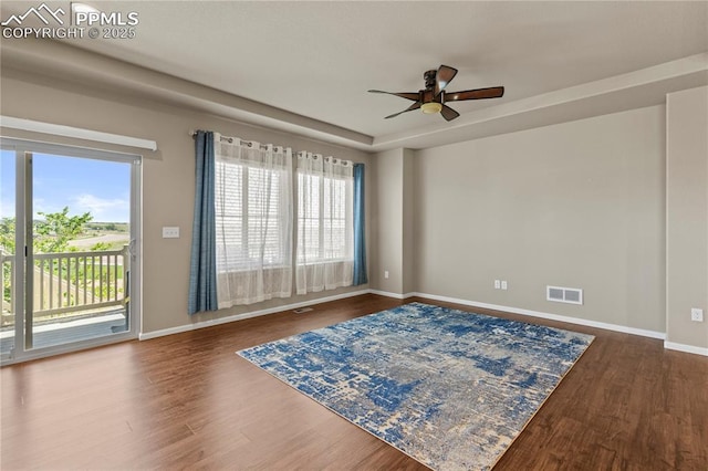 6646 Backcountry Loop, Colorado Springs, CO 80927 - empty room featuring plenty of natural light, a ceiling fan, and dark wood-style floors