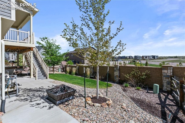 6646 Backcountry Loop, Colorado Springs, CO 80927 - fenced backyard with stairway, a patio, and an outdoor fire pit