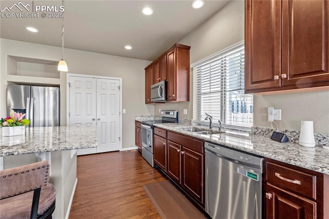 6646 Backcountry Loop, Colorado Springs, CO 80927 - kitchen featuring appliances with stainless steel finishes, dark wood-style floors, light stone counters, decorative light fixtures, and recessed lighting