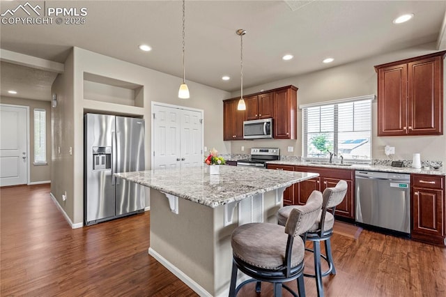 6646 Backcountry Loop, Colorado Springs, CO 80927 - kitchen with stainless steel appliances, dark wood finished floors, a breakfast bar, and recessed lighting
