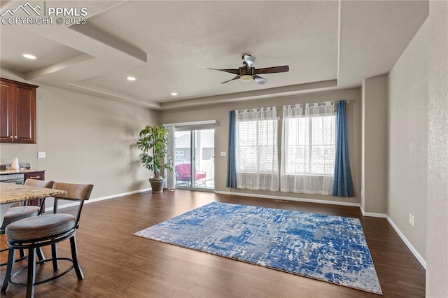 6646 Backcountry Loop, Colorado Springs, CO 80927 - living room with ceiling fan, dark wood-style floors, a textured ceiling, a raised ceiling, and recessed lighting