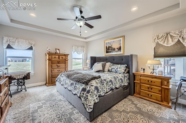 10394 Beckham St, Peyton, CO 80831 - bedroom with a tray ceiling, multiple windows, baseboards, and recessed lighting