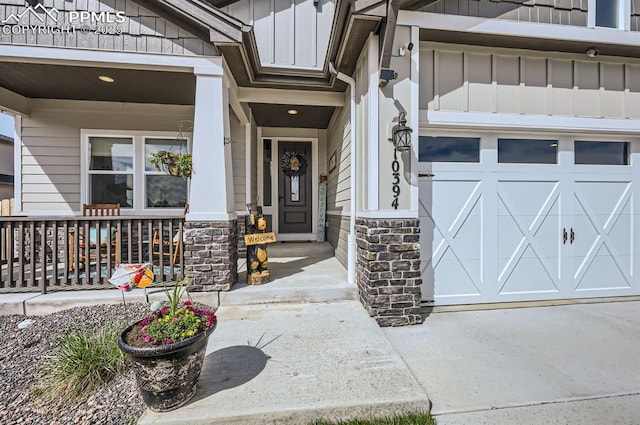 10394 Beckham St, Peyton, CO 80831 - view of exterior entry with covered porch, stone siding, and board and batten siding