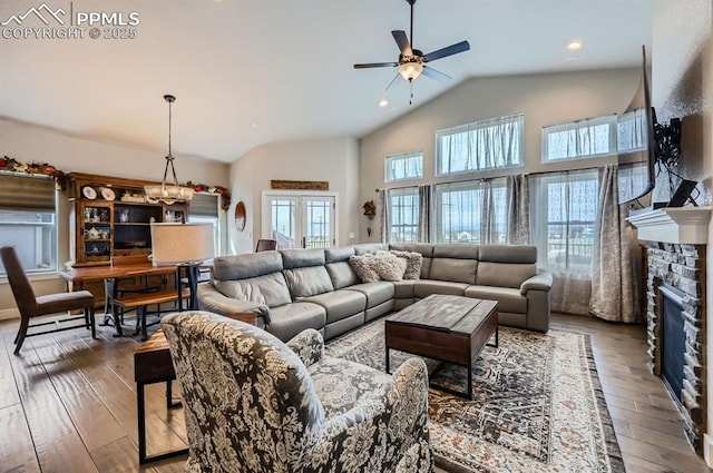 10394 Beckham St, Peyton, CO 80831 - living room featuring ceiling fan, vaulted ceiling, wood-type flooring, a stone fireplace, and recessed lighting