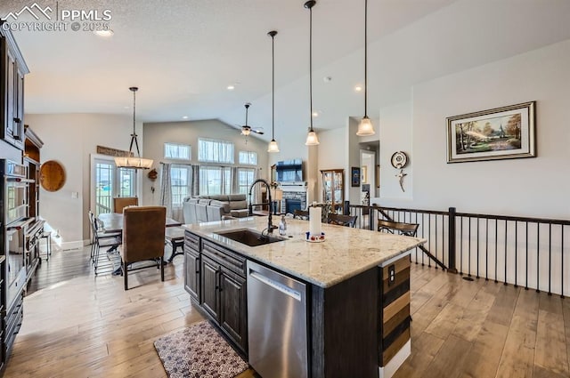 10394 Beckham St, Peyton, CO 80831 - kitchen featuring a sink, stainless steel appliances, ceiling fan, lofted ceiling, and light wood-style floors