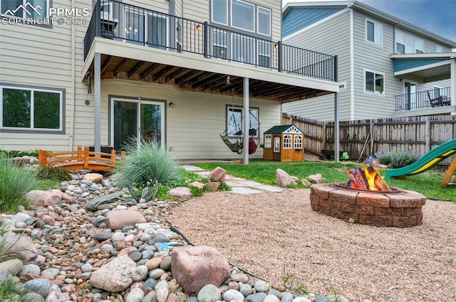 6927 Passing Sky Dr, Colorado Springs, CO 80911 - rear view of house featuring an outdoor fire pit and a balcony