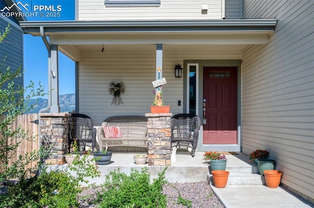 6927 Passing Sky Dr, Colorado Springs, CO 80911 - view of exterior entry featuring a porch and a mountain view