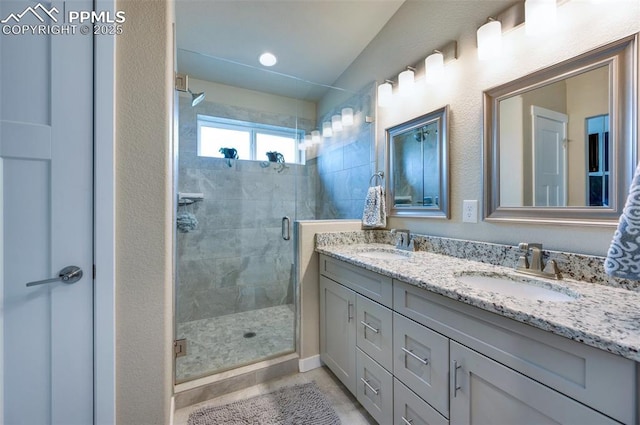 6927 Passing Sky Dr, Colorado Springs, CO 80911 - full bathroom featuring double vanity and a stall shower