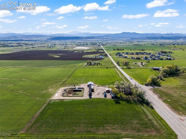 aerial view of sparsely populated area featuring a mountainous background