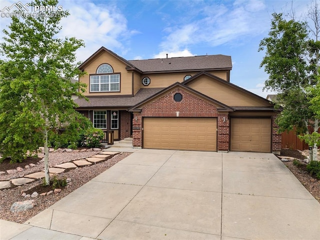 10398 Mount Evans Dr, Peyton, CO 80831 - traditional home with driveway, a garage, brick siding, and roof with shingles