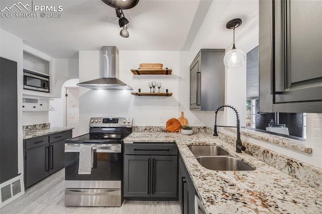 5362 S Cedar St, Littleton, CO 80120 - kitchen featuring appliances with stainless steel finishes, wall chimney range hood, a sink, and decorative backsplash
