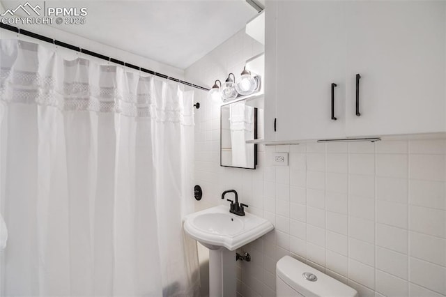 5362 S Cedar St, Littleton, CO 80120 - bathroom with tile walls, toilet, and backsplash