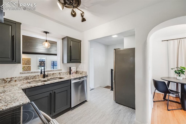 5362 S Cedar St, Littleton, CO 80120 - kitchen with a sink, appliances with stainless steel finishes, light wood-style flooring, and light stone counters