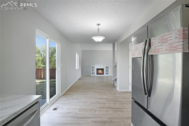 502 Fountain Mesa Rd, Fountain, CO 80817 - corridor with light wood finished floors and a textured ceiling