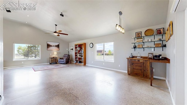14870 Reiner Ct, Peyton, CO 80831 - living area featuring speckle patterned floor, healthy amount of natural light, ceiling fan, baseboards, and lofted ceiling