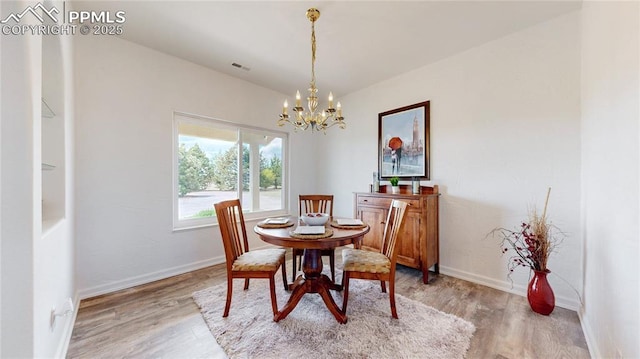14870 Reiner Ct, Peyton, CO 80831 - dining area featuring a chandelier, light wood-style flooring, and baseboards