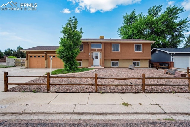 3905 Allgood Dr, Colorado Springs, CO 80911 - bi-level home featuring concrete driveway, a fenced front yard, and an attached garage