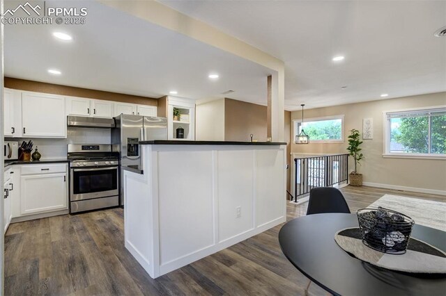 3905 Allgood Dr, Colorado Springs, CO 80911 - kitchen featuring appliances with stainless steel finishes, under cabinet range hood, dark countertops, dark wood-style flooring, and recessed lighting