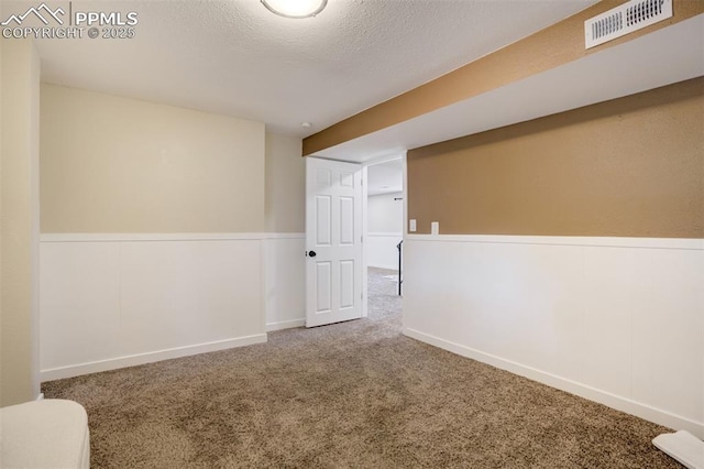 3905 Allgood Dr, Colorado Springs, CO 80911 - carpeted empty room with a wainscoted wall and a textured ceiling