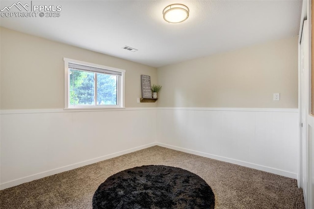 3905 Allgood Dr, Colorado Springs, CO 80911 - spare room featuring carpet and a wainscoted wall