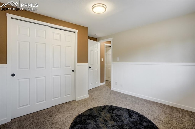 3905 Allgood Dr, Colorado Springs, CO 80911 - unfurnished bedroom featuring wainscoting, carpet flooring, and a closet
